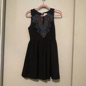 Black dress with geometric embroidery